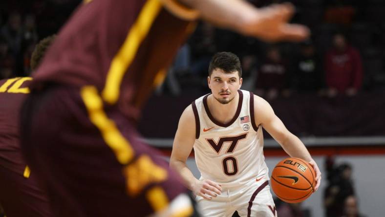 Nov 28, 2022; Blacksburg, Virginia, USA; Virginia Tech Hokies guard Hunter Cattoor (0) dribbles against the Minnesota Golden Gophers defense in the second half at Cassell Coliseum. Mandatory Credit: Lee Luther Jr.-USA TODAY Sports