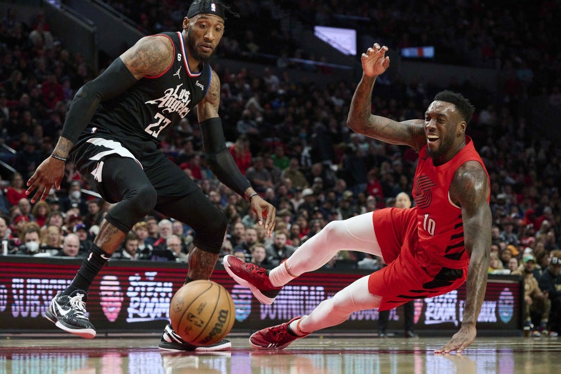 Nov 29, 2022; Portland, Oregon, USA;  Portland Trail Blazers forward Nassir Little (10) injures himself during the second half chasing the basketball against LA Clippers forward Robert Covington (23) at Moda Center. The Clippers won the game 118-112. Mandatory Credit: Troy Wayrynen-USA TODAY Sports