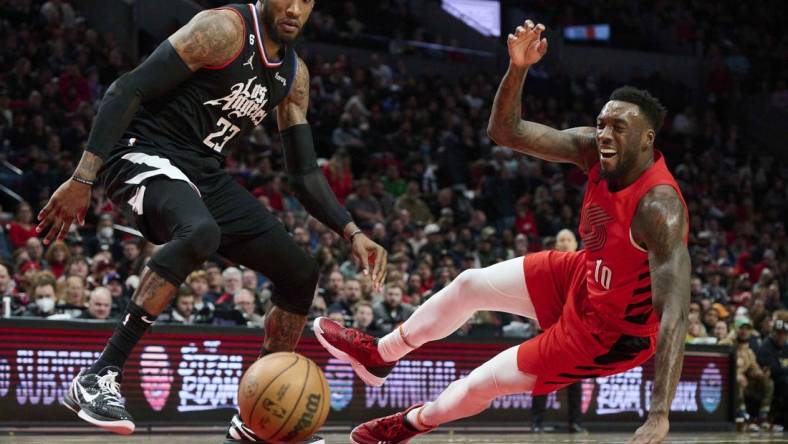 Nov 29, 2022; Portland, Oregon, USA;  Portland Trail Blazers forward Nassir Little (10) injures himself during the second half chasing the basketball against LA Clippers forward Robert Covington (23) at Moda Center. The Clippers won the game 118-112. Mandatory Credit: Troy Wayrynen-USA TODAY Sports