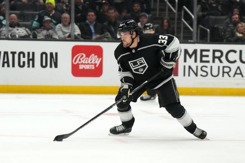 Nov 29, 2022; Los Angeles, California, USA; LA Kings right wing Viktor Arvidsson (33) handles the puck against the Seattle Kraken in the second period at Crypto.com Arena. Mandatory Credit: Kirby Lee-USA TODAY Sports