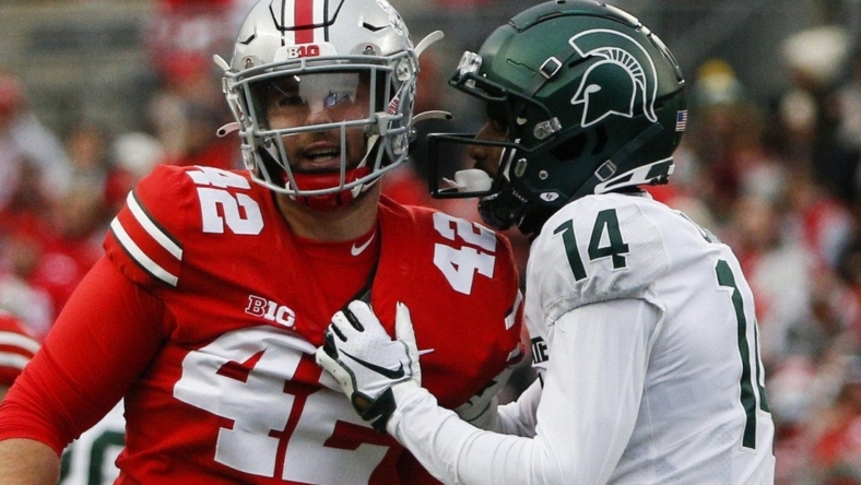 Michigan State Spartans cornerback Khary Crump (14) and Ohio State Buckeyes long snapper Bradley Robinson (42) share words after a punt return.

Syndication The Columbus Dispatch