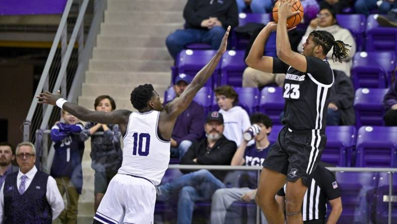 Nov 30, 2022; Fort Worth, Texas, USA; Providence Friars forward Bryce Hopkins (23) shoots over TCU Horned Frogs guard Damion Baugh (10) during the first half at Ed and Rae Schollmaier Arena. Mandatory Credit: Jerome Miron-USA TODAY Sports