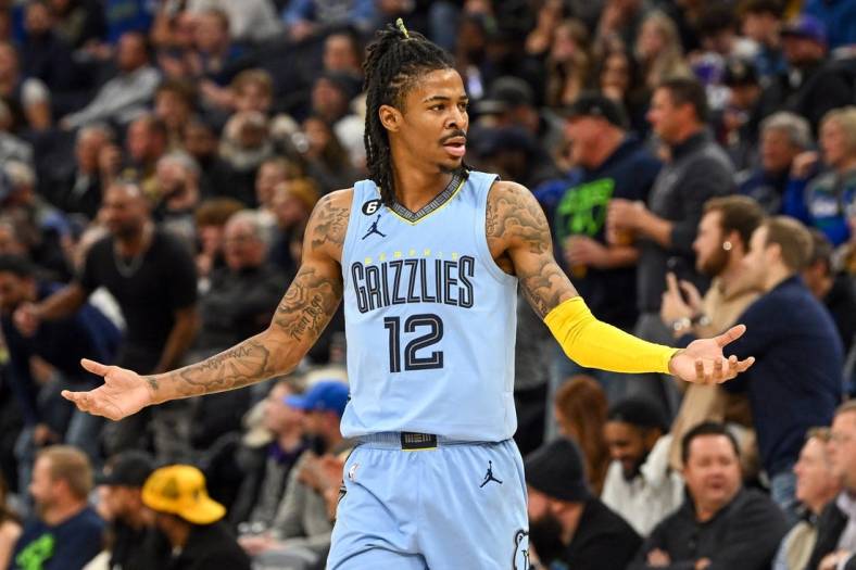 Nov 30, 2022; Minneapolis, Minnesota, USA;  Memphis Grizzlies guard Ja Morant (12) questions a delay of game call made on him against the Minnesota Timberwolves during the second quarter at Target Center. Mandatory Credit: Nick Wosika-USA TODAY Sports