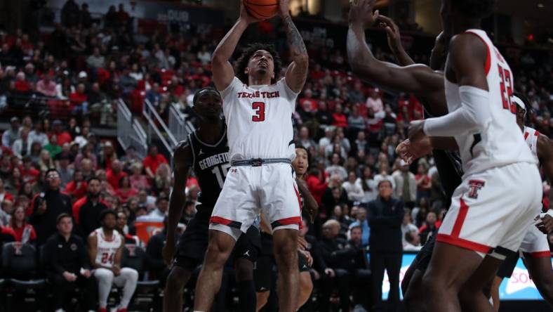 Nov 30, 2022; Lubbock, Texas, USA;  Texas Tech Red Raiders guard D Maurian Williams (3) shoots in front of Georgetown Hoyas forward Bryson Mozone (15) in the second half at United Supermarkets Arena. Mandatory Credit: Michael C. Johnson-USA TODAY Sports