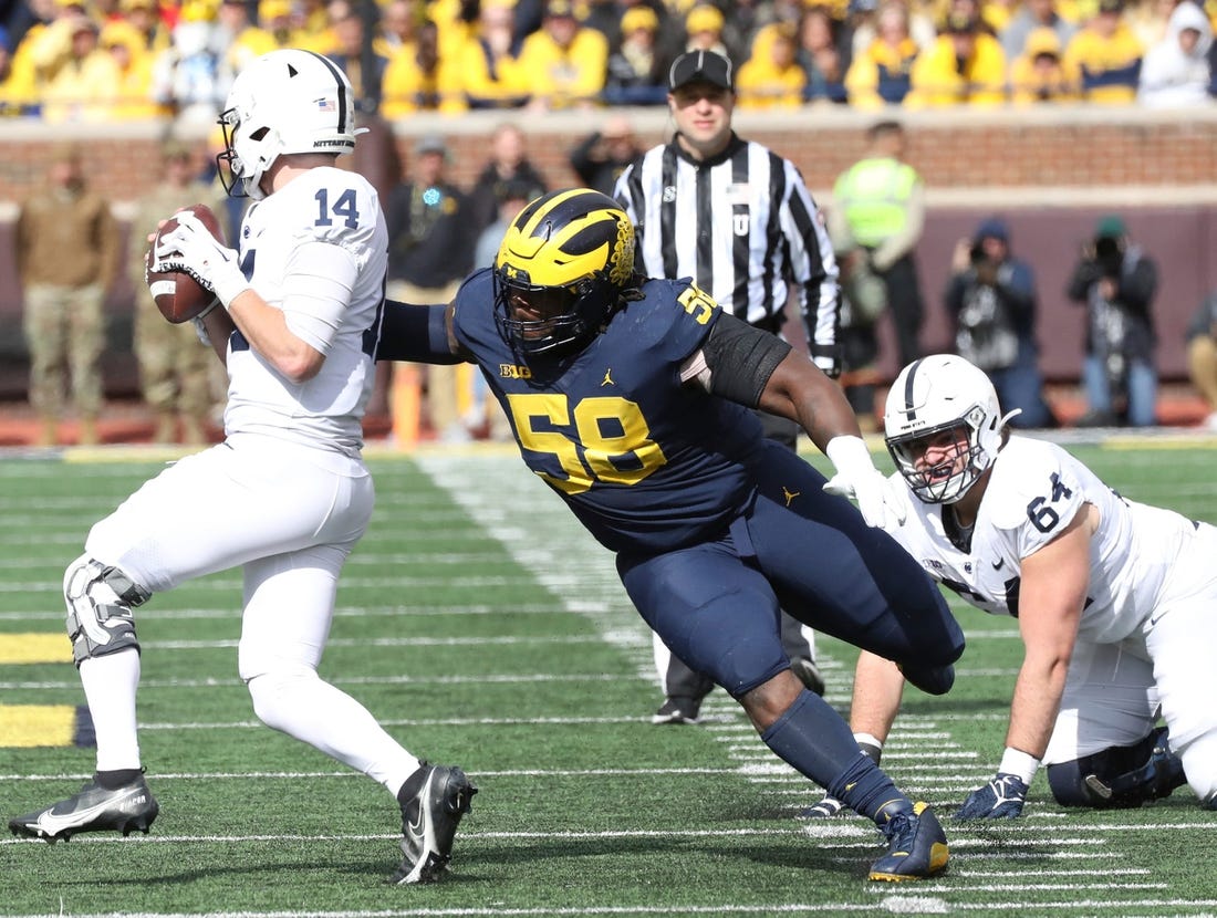 Michigan defensive lineman Mazi Smith (58) pressures Penn State quarterback Sean Clifford (14) during the second half Oct. 15, 2022 at Michigan Stadium in Ann Arbor.

Michpenn 101522 Kd 0016511