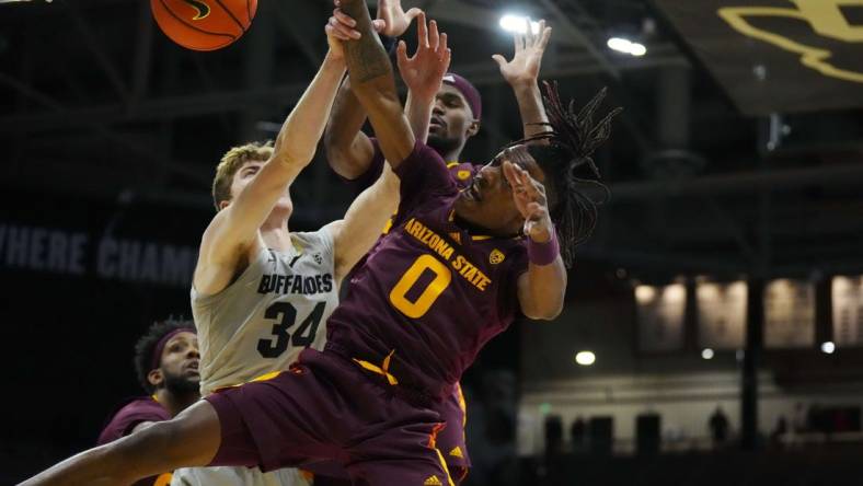 Dec 1, 2022; Boulder, Colorado, USA; Arizona State Sun Devils guard DJ Horne (0) and Colorado Buffaloes center Lawson Lovering (34) reach for a loose ball in the first half at the CU Events Center. Mandatory Credit: Ron Chenoy-USA TODAY Sports