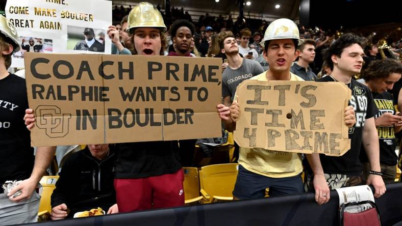 Dec 1, 2022; Boulder, Colorado, USA; Colorado Buffaloes student fans hold signs in reference to Jackson State University head coach Deion Sanders (not pictured) before the game against the Arizona State Sun Devils at the CU Events Center. Mandatory Credit: Ron Chenoy-USA TODAY Sports