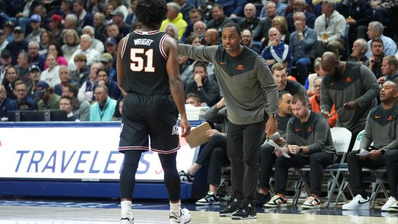 Dec 1, 2022; Storrs, Connecticut, USA; Oklahoma State Cowboys head coach Mike Boynton Jr. speaks with guard John-Michael Wright (51) during the first half against the Connecticut Huskies at Harry A. Gampel Pavilion. Mandatory Credit: Gregory Fisher-USA TODAY Sports