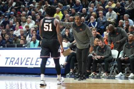 Dec 1, 2022; Storrs, Connecticut, USA; Oklahoma State Cowboys head coach Mike Boynton Jr. speaks with guard John-Michael Wright (51) during the first half against the Connecticut Huskies at Harry A. Gampel Pavilion. Mandatory Credit: Gregory Fisher-USA TODAY Sports
