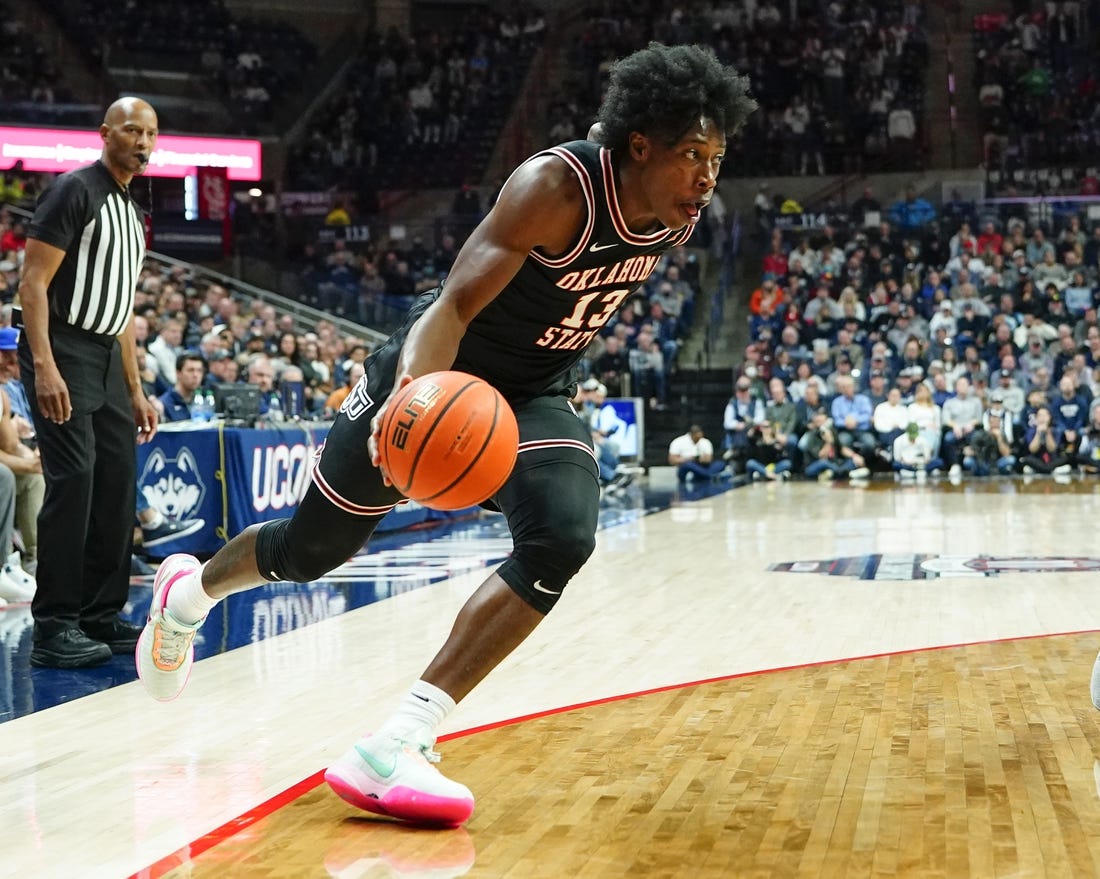 Dec 1, 2022; Storrs, Connecticut, USA; Oklahoma State Cowboys guard Quinn Williams (13) dribbles the ball toward the basket against the Connecticut Huskies during the second half at Harry A. Gampel Pavilion. Mandatory Credit: Gregory Fisher-USA TODAY Sports