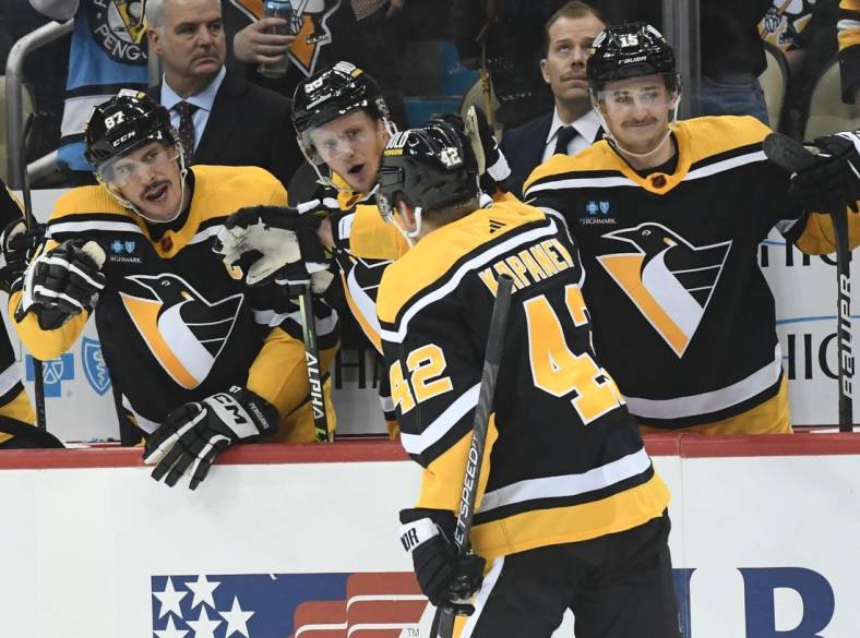 Dec 1, 2022; Pittsburgh, Pennsylvania, USA; Pittsburgh Penguins right wing Kasperi Kapanen (42) is greeted by center Sidney Crosby (87), left wing Jake Guentzel (59) and right wing Josh Archibald (15) after scoring against the Vegas Golden Knights during the third period at PPG Paints Arena. Mandatory Credit: Philip G. Pavely-USA TODAY Sports
