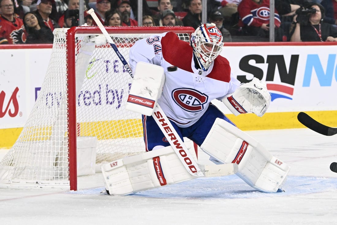 Dec 1, 2022; Calgary, Alberta, CAN; Montreal Canadiens  goalie Jake Allen (34) stops a shot from the Calgary Flames in the second period at Scotiabank Saddledome. Mandatory Credit: Candice Ward-USA TODAY Sports