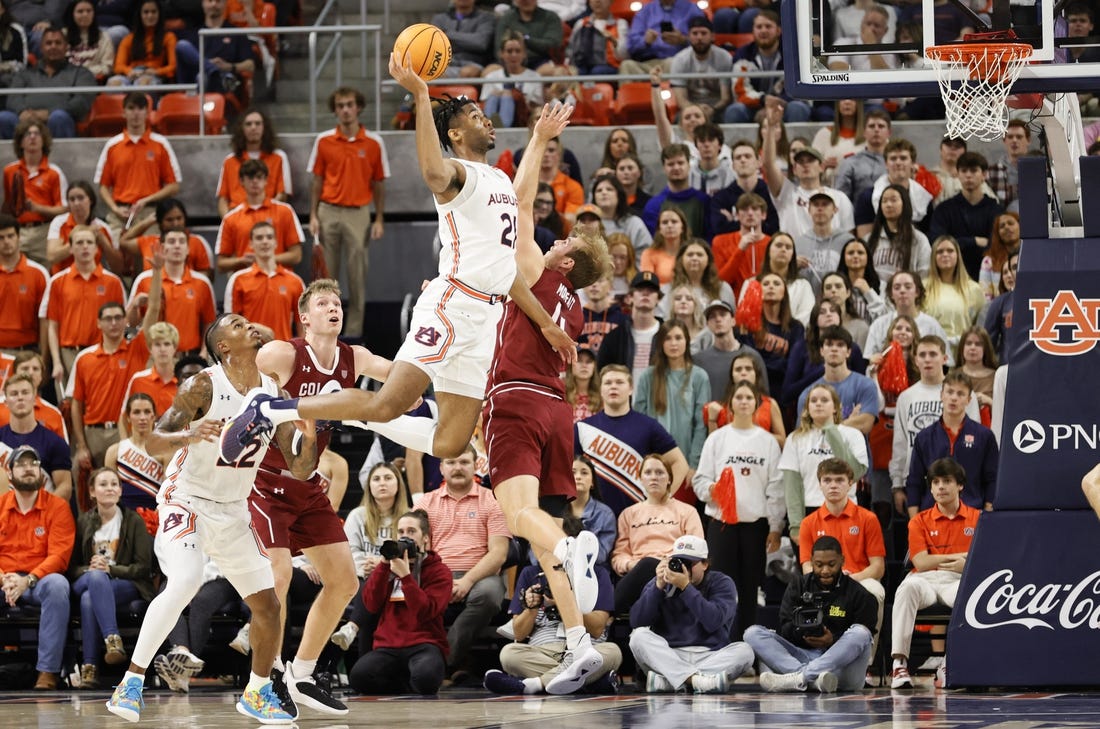 Dec 2, 2022; Auburn, Alabama, USA;  Auburn Tigers forward Yohan Traore (21) takes a shot over Colgate Raiders forward Ryan Moffatt (4) during the first half at Neville Arena. Mandatory Credit: John Reed-USA TODAY Sports