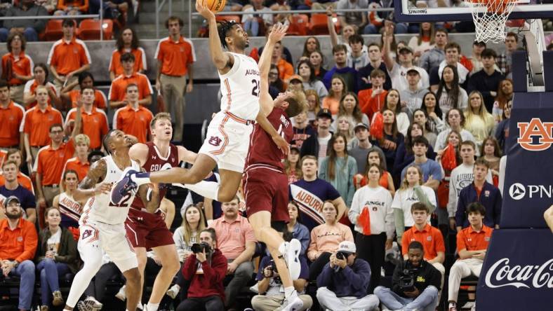 Dec 2, 2022; Auburn, Alabama, USA;  Auburn Tigers forward Yohan Traore (21) takes a shot over Colgate Raiders forward Ryan Moffatt (4) during the first half at Neville Arena. Mandatory Credit: John Reed-USA TODAY Sports