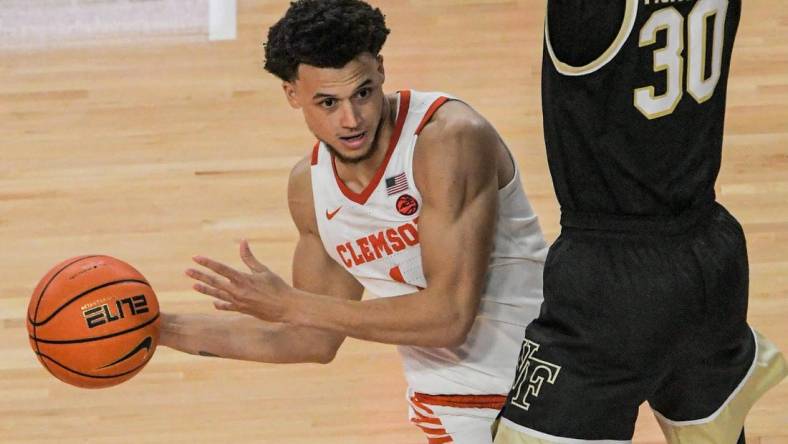 Dec 2, 2022; Clemson, SC, USA;  Clemson junior guard Chase Hunter (1) passes around Wake Forest guard Damari Monsanto (30) during the second half at Littlejohn Coliseum Friday, December 2, 2022. Mandatory Credit: Ken Ruinard/USA TODAY-USA TODAY NETWORK