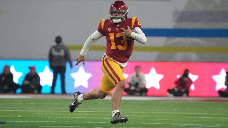 Dec 2, 2022; Las Vegas, NV, USA; Southern California Trojans quarterback Caleb Williams (13) carries the ball on a 59-yard run against the Utah Utes in the first half of the Pac-12 Championship at Allegiant Stadium. Mandatory Credit: Kirby Lee-USA TODAY Sports