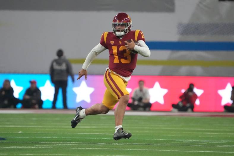 Dec 2, 2022; Las Vegas, NV, USA; Southern California Trojans quarterback Caleb Williams (13) carries the ball on a 59-yard run against the Utah Utes in the first half of the Pac-12 Championship at Allegiant Stadium. Mandatory Credit: Kirby Lee-USA TODAY Sports