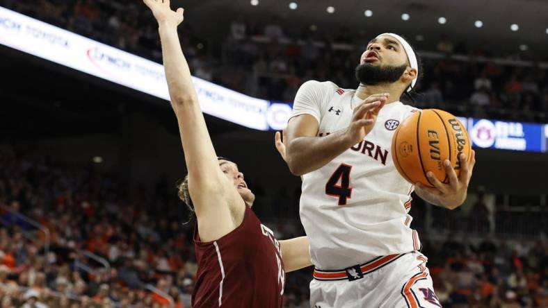 Dec 2, 2022; Auburn, Alabama, USA;  Auburn Tigers forward Johni Broome (4) gets past Colgate Raiders forward Keegan Records (14) for a shot during the second half at Neville Arena. Mandatory Credit: John Reed-USA TODAY Sports