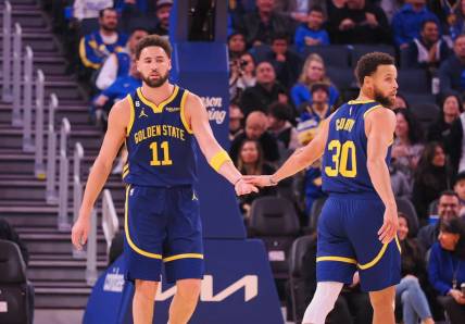 Dec 2, 2022; San Francisco, California, USA; Golden State Warriors shooting guard Klay Thompson (11) and point guard Stephen Curry (30) high five after Thompson scored with an assist from Curry during the first quarter against the Chicago Bulls at Chase Center. Mandatory Credit: Kelley L Cox-USA TODAY Sports