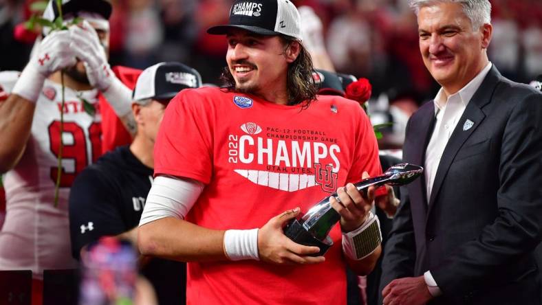 Dec 2, 2022; Las Vegas, NV, USA; Utah Utes quarterback Cameron Rising (7) celebrates after being named MVP in the victory against the Southern California Trojans in the PAC-12 Football Championship at Allegiant Stadium. Mandatory Credit: Gary A. Vasquez-USA TODAY Sports