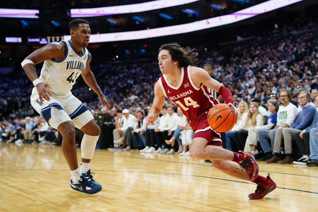 Dec 3, 2022; Philadelphia, Pennsylvania, USA; Oklahoma Sooners guard Bijan Cortes (14) dribbles the ball against Villanova Wildcats forward Eric Dixon (43) during the first half at Wells Fargo Center. Mandatory Credit: Gregory Fisher-USA TODAY Sports