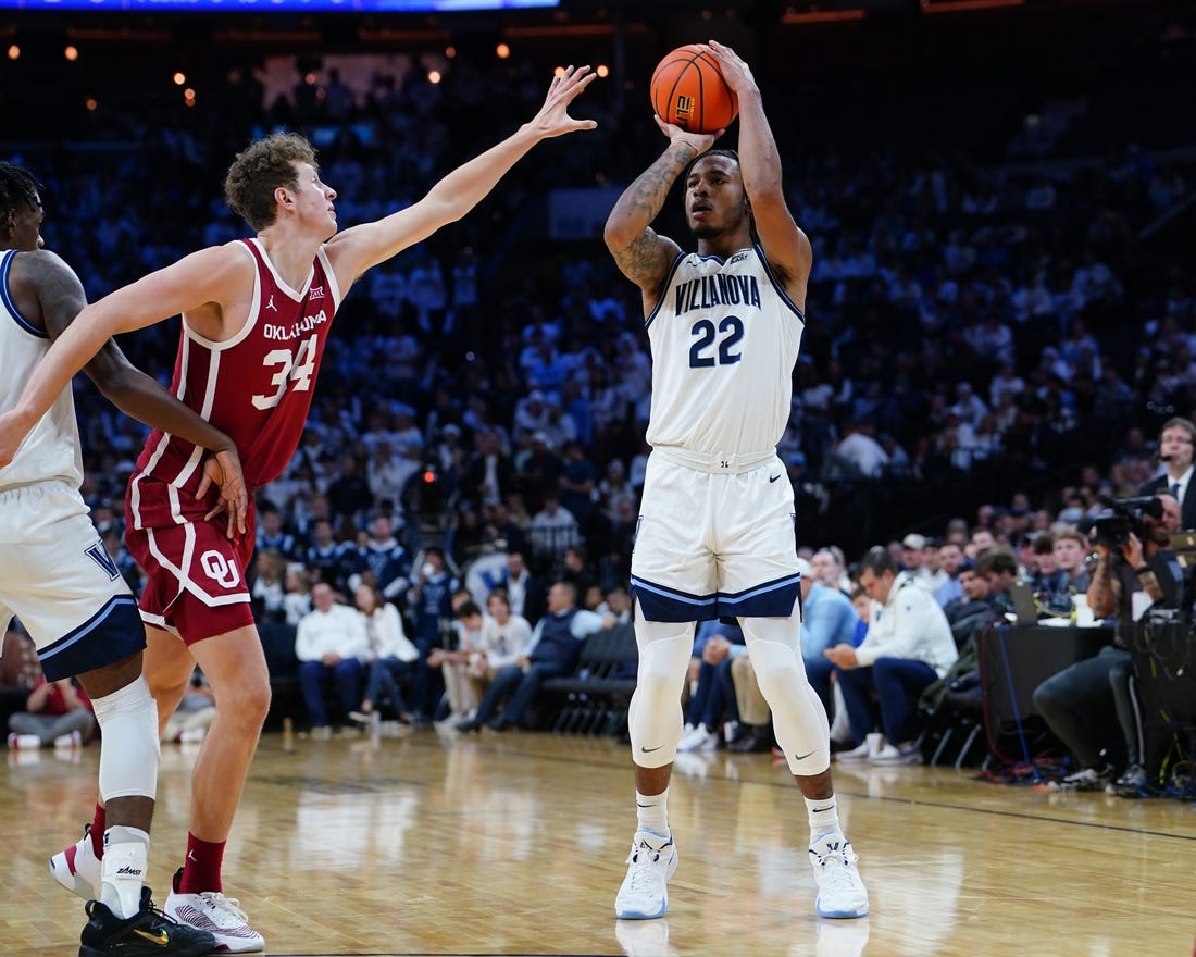 Dec 3, 2022; Philadelphia, Pennsylvania, USA; Villanova Wildcats forward Cam Whitmore (22) shoots a three point jump shot against Oklahoma Sooners forward Jacob Groves (34)during the second half at Wells Fargo Center. Mandatory Credit: Gregory Fisher-USA TODAY Sports