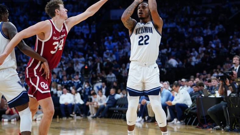 Dec 3, 2022; Philadelphia, Pennsylvania, USA; Villanova Wildcats forward Cam Whitmore (22) shoots a three point jump shot against Oklahoma Sooners forward Jacob Groves (34)during the second half at Wells Fargo Center. Mandatory Credit: Gregory Fisher-USA TODAY Sports