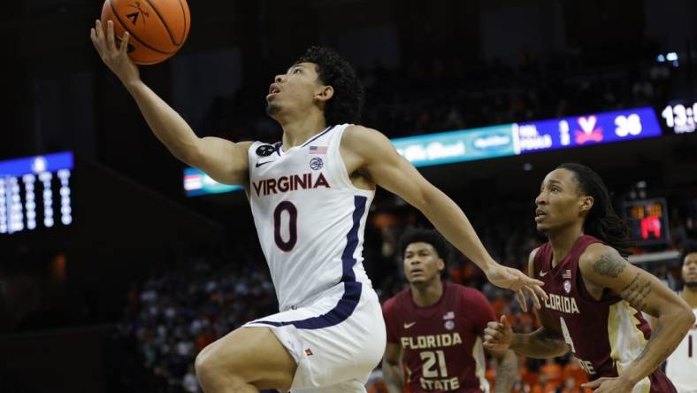 Dec 3, 2022; Charlottesville, Virginia, USA; Virginia Cavaliers guard Kihei Clark (0) shoots the ball as Florida State Seminoles guard Caleb Mills (4) looks on in the second half at John Paul Jones Arena. Mandatory Credit: Geoff Burke-USA TODAY Sports