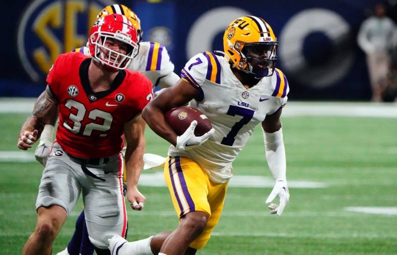 Dec 3, 2022; Atlanta, GA, USA; LSU Tigers wide receiver Kayshon Boutte (7) carries the ball for a receiving touchdown against the Georgia Bulldogs during the first quarter of the SEC Championship game at Mercedes-Benz Stadium. Mandatory Credit: John David Mercer-USA TODAY Sports