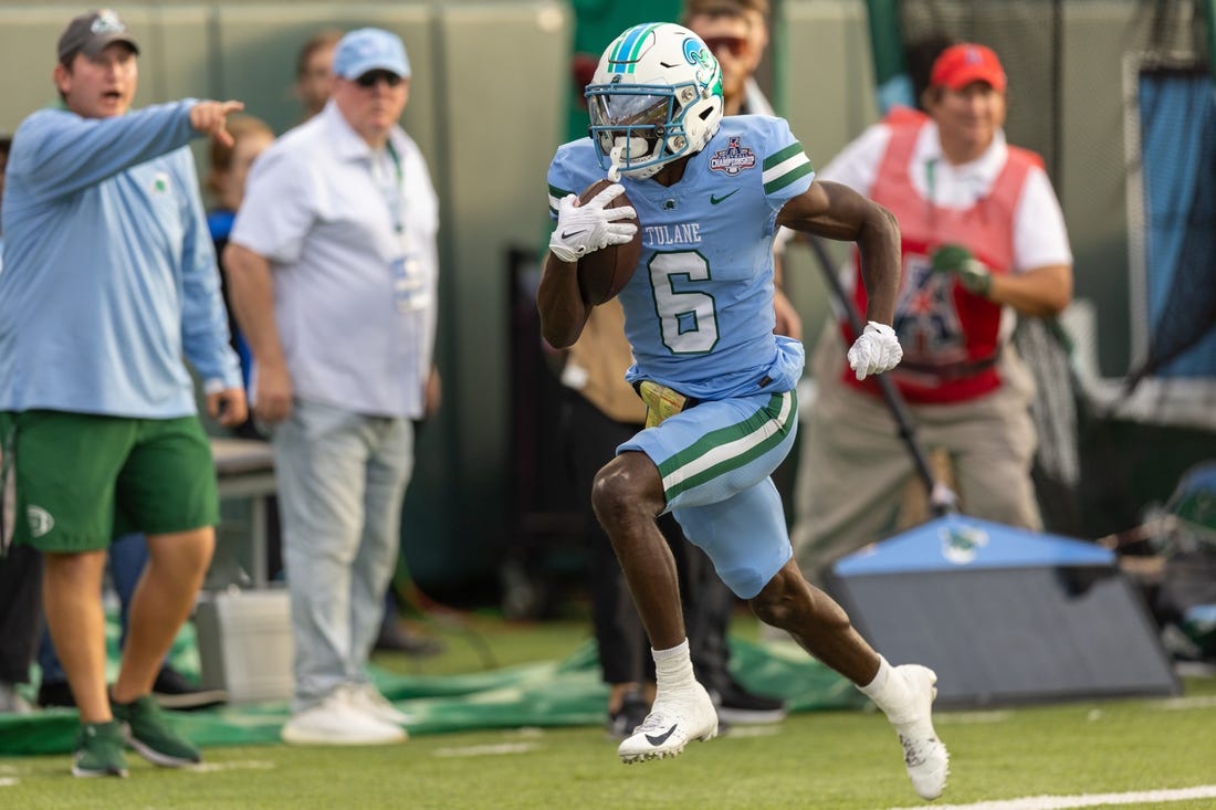 Dec 3, 2022; New Orleans, Louisiana, USA; Tulane Green Wave wide receiver Lawrence Keys III (6) catches a pass and runs in for a touchdown against the UCF Knights during the first half  at Yulman Stadium. Mandatory Credit: Stephen Lew-USA TODAY Sports