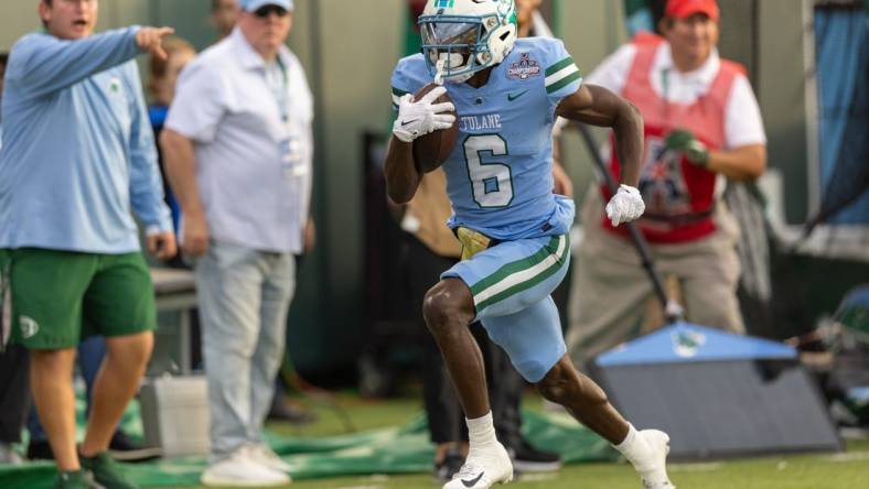 Dec 3, 2022; New Orleans, Louisiana, USA; Tulane Green Wave wide receiver Lawrence Keys III (6) catches a pass and runs in for a touchdown against the UCF Knights during the first half  at Yulman Stadium. Mandatory Credit: Stephen Lew-USA TODAY Sports