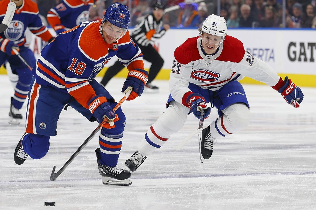 Dec 3, 2022; Edmonton, Alberta, CAN; Montreal Canadiens defensemen Kaiden Guhle (21) chases Edmonton Oilers forward Zach Hyman (18) up the ice during the first period at Rogers Place. Mandatory Credit: Perry Nelson-USA TODAY Sports