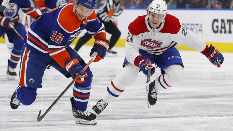 Dec 3, 2022; Edmonton, Alberta, CAN; Montreal Canadiens defensemen Kaiden Guhle (21) chases Edmonton Oilers forward Zach Hyman (18) up the ice during the first period at Rogers Place. Mandatory Credit: Perry Nelson-USA TODAY Sports