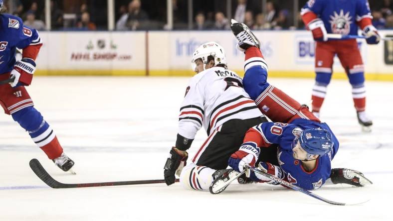 Dec 3, 2022; New York, New York, USA;  Chicago Blackhawks defenseman Jake McCabe (6) and New York Rangers left wing Chris Kreider (20) collide on the ice in the first period at Madison Square Garden. Mandatory Credit: Wendell Cruz-USA TODAY Sports