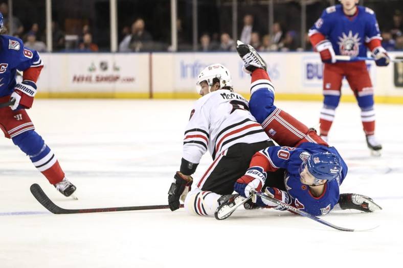 Dec 3, 2022; New York, New York, USA;  Chicago Blackhawks defenseman Jake McCabe (6) and New York Rangers left wing Chris Kreider (20) collide on the ice in the first period at Madison Square Garden. Mandatory Credit: Wendell Cruz-USA TODAY Sports