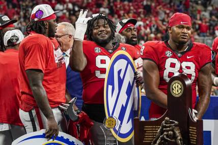Dec 3, 2022; Atlanta, GA, USA; Georgia Bulldogs players react after defeating the LSU Tigers in the SEC Championship game at Mercedes-Benz Stadium. Mandatory Credit: Dale Zanine-USA TODAY Sports