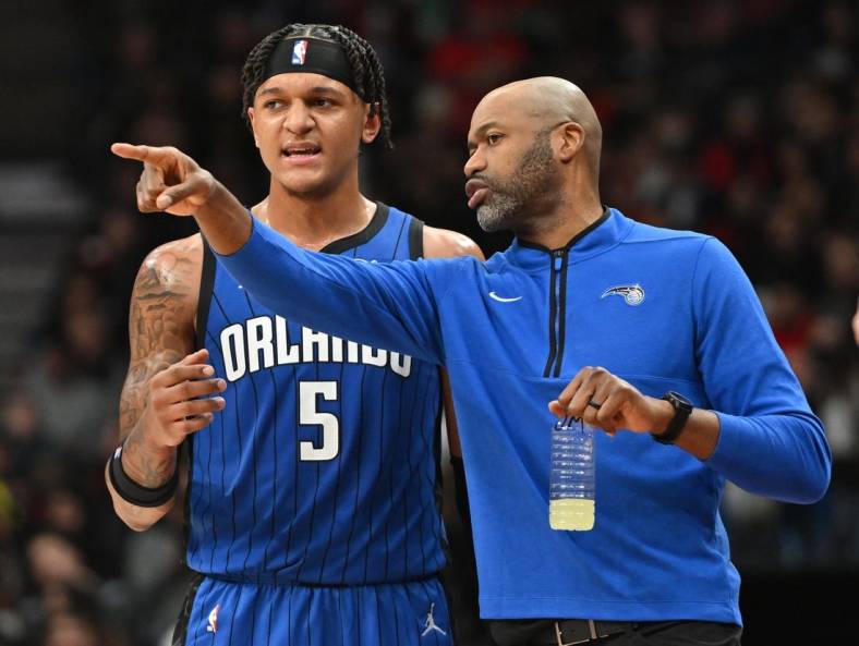 Dec 3, 2022; Toronto, Ontario, CAN;  Orlando Magic head coach Jamahl Mosley speaks to forward Paolo Banchero (5) in the first half against the Toronto Raptors at Scotiabank Arena. Mandatory Credit: Dan Hamilton-USA TODAY Sports