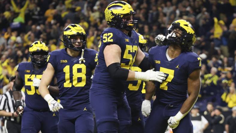 Dec 3, 2022; Indianapolis, Indiana, USA; Michigan Wolverines running back Donovan Edwards (7) celebrates after scoring on a 27-yard touchdown run during the second half of the Big Ten Championship against the Purdue Boilermakers at Lucas Oil Stadium. Mandatory Credit: Trevor Ruszkowski-USA TODAY Sports