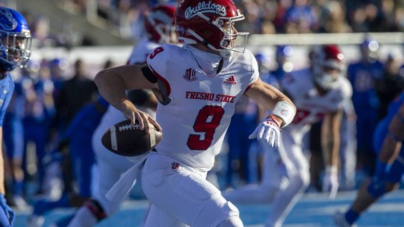 Dec 3, 2022; Boise, Idaho, USA;  Fresno State Bulldogs quarterback Jake Haener (9) rolls out during the first half of the Mountain West Championship game versus the Boise State Broncos at Albertsons Stadium. Mandatory Credit: Brian Losness-USA TODAY Sports