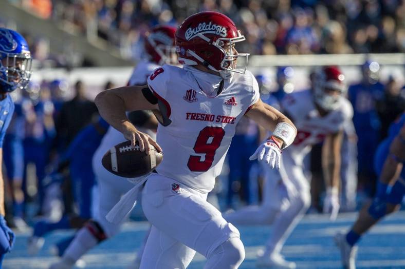 Dec 3, 2022; Boise, Idaho, USA;  Fresno State Bulldogs quarterback Jake Haener (9) rolls out during the first half of the Mountain West Championship game versus the Boise State Broncos at Albertsons Stadium. Mandatory Credit: Brian Losness-USA TODAY Sports