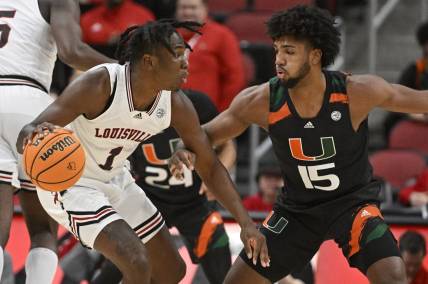 Dec 4, 2022; Louisville, Kentucky, USA;  Louisville Cardinals guard Mike James (1) dribble against Miami (Fl) Hurricanes forward Norchad Omier (15) during the first half at KFC Yum! Center. Mandatory Credit: Jamie Rhodes-USA TODAY Sports