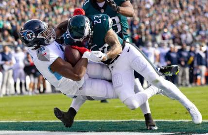 Dec 4, 2022; Philadelphia, Pennsylvania, USA;  Tennessee Titans wide receiver Treylon Burks (16) is hit by Philadelphia Eagles safety Marcus Epps (22) as he makes a touchdown catch during the first quarter at Lincoln Financial Field. Mandatory Credit: Bill Streicher-USA TODAY Sports