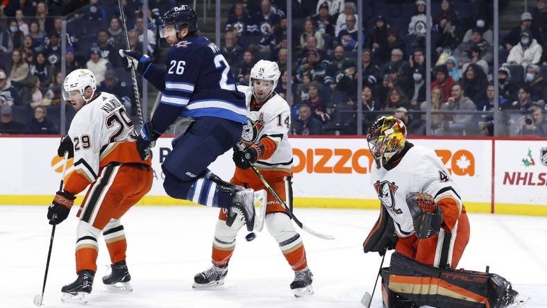 Dec 4, 2022; Winnipeg, Manitoba, CAN; Winnipeg Jets right wing Blake Wheeler (26) leaps from the puck in front of Anaheim Ducks goaltender Anthony Stolarz (41) in the second period at Canada Life Centre. Mandatory Credit: James Carey Lauder-USA TODAY Sports