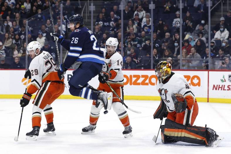 Dec 4, 2022; Winnipeg, Manitoba, CAN; Winnipeg Jets right wing Blake Wheeler (26) leaps from the puck in front of Anaheim Ducks goaltender Anthony Stolarz (41) in the second period at Canada Life Centre. Mandatory Credit: James Carey Lauder-USA TODAY Sports