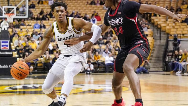 Dec 4, 2022; Columbia, Missouri, USA; Missouri Tigers guard DeAndre Gholston (4) dribbles as Southeast Missouri State Redhawks center Nate Johnson (14) defends during the first half at Mizzou Arena. Mandatory Credit: Denny Medley-USA TODAY Sports