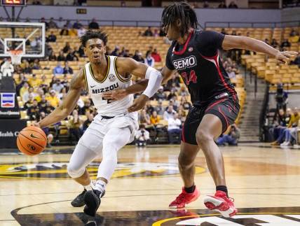 Dec 4, 2022; Columbia, Missouri, USA; Missouri Tigers guard DeAndre Gholston (4) dribbles as Southeast Missouri State Redhawks center Nate Johnson (14) defends during the first half at Mizzou Arena. Mandatory Credit: Denny Medley-USA TODAY Sports