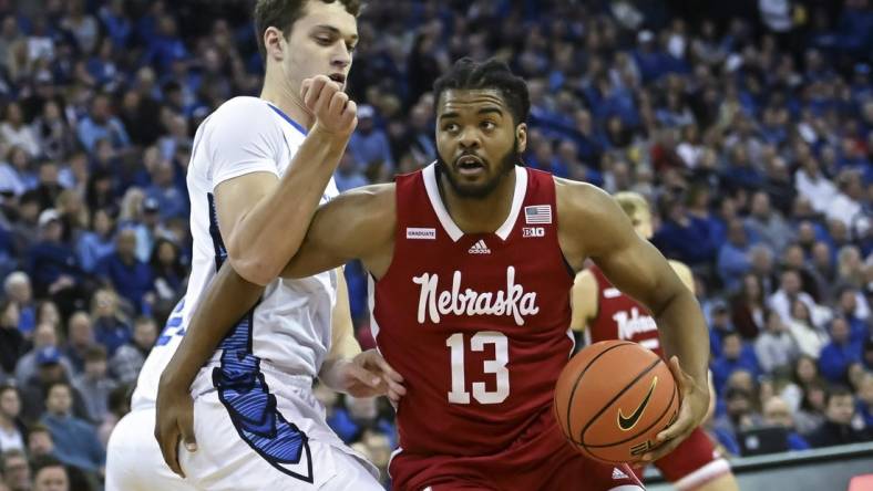 Dec 4, 2022; Omaha, Nebraska, USA;  Nebraska Cornhuskers forward Derrick Walker (13) drives against Creighton Bluejays center Ryan Kalkbrenner (11) in the first half at CHI Health Center Omaha. Mandatory Credit: Steven Branscombe-USA TODAY Sports