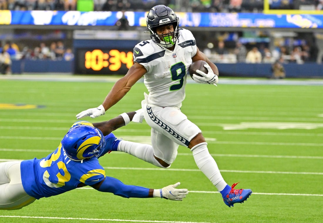 Dec 4, 2022; Inglewood, California, USA; Seattle Seahawks running back Kenneth Walker III (9) runs past Los Angeles Rams safety Nick Scott (33) for a first down in the first half at SoFi Stadium. Mandatory Credit: Jayne Kamin-Oncea-USA TODAY Sports