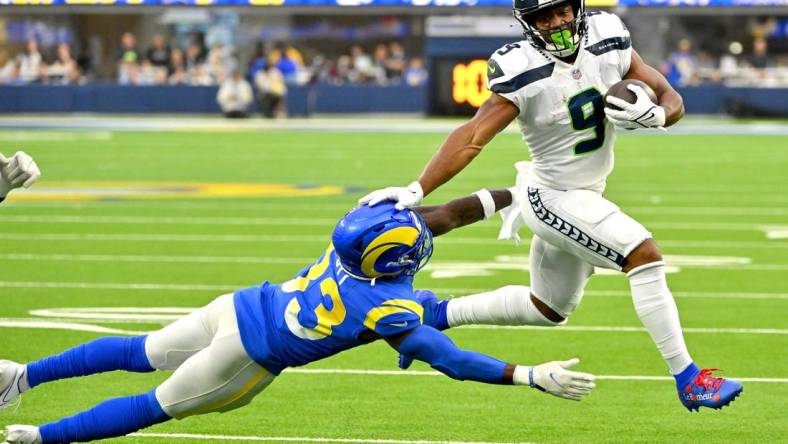 Dec 4, 2022; Inglewood, California, USA; Seattle Seahawks running back Kenneth Walker III (9) runs past Los Angeles Rams safety Nick Scott (33) for a first down in the first half at SoFi Stadium. Mandatory Credit: Jayne Kamin-Oncea-USA TODAY Sports