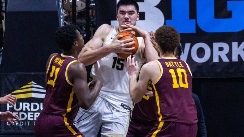 Dec 4, 2022; West Lafayette, Indiana, USA; Purdue Boilermakers center Zach Edey (15) rebounds the ball while Minnesota Golden Gophers forward Jamison Battle (10) and  guard Jackson Purcell (11) defend in the first half at Mackey Arena. Mandatory Credit: Trevor Ruszkowski-USA TODAY Sports